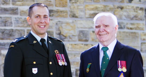 Two war amputee veterans standing side by side.